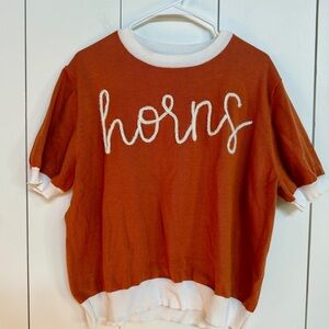 Queen of Sparkles

Burnt Orange Short Sleeve Sweater with White Sparkle Trim .